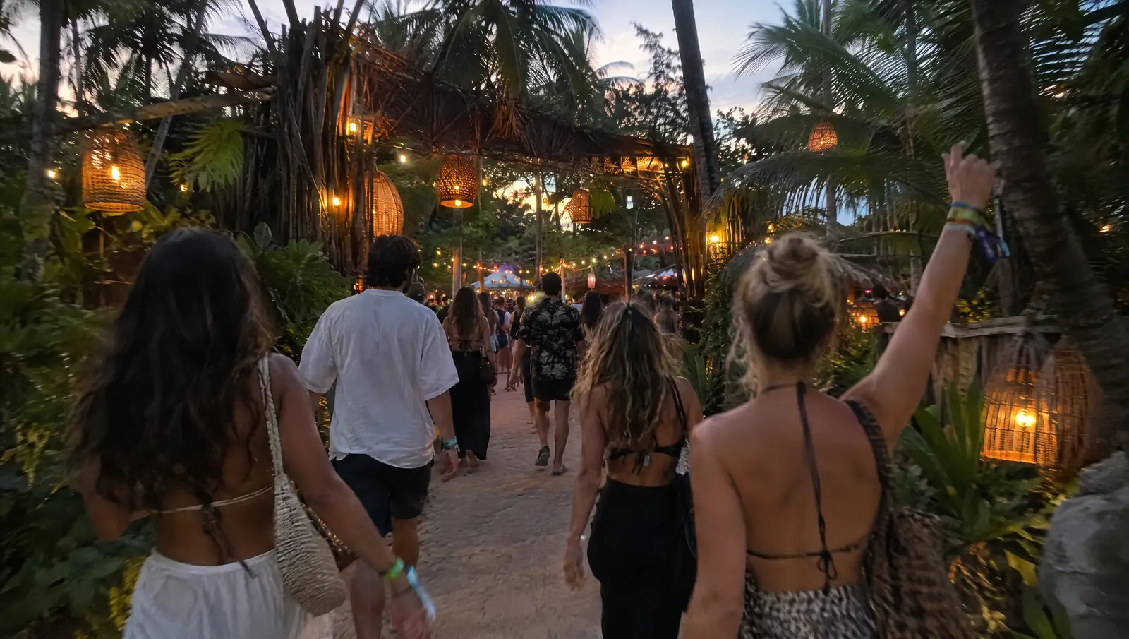 Friends walking to a jungle festival in Tulum at dusk