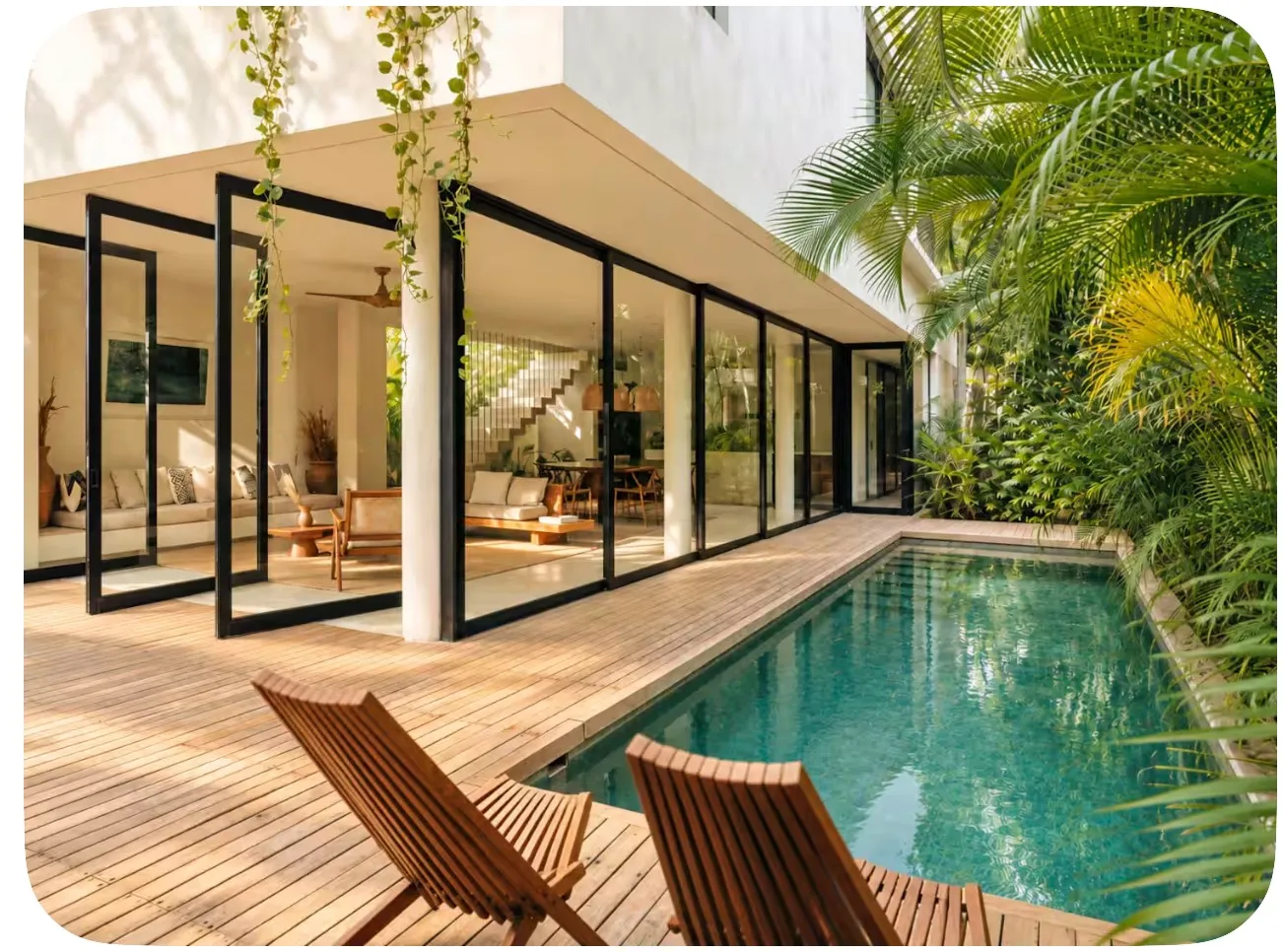 Pool and glass façade at Casa Areca in Aldea Zama, Tulum