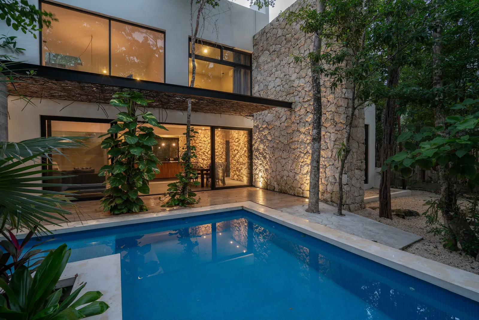 Pool lit at dusk at Villas Twelve #5 in Tulum